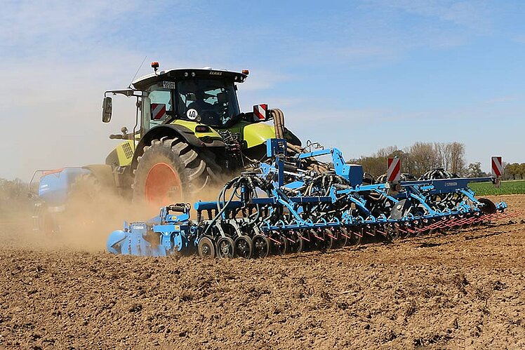 Tractor with seed drill in the field